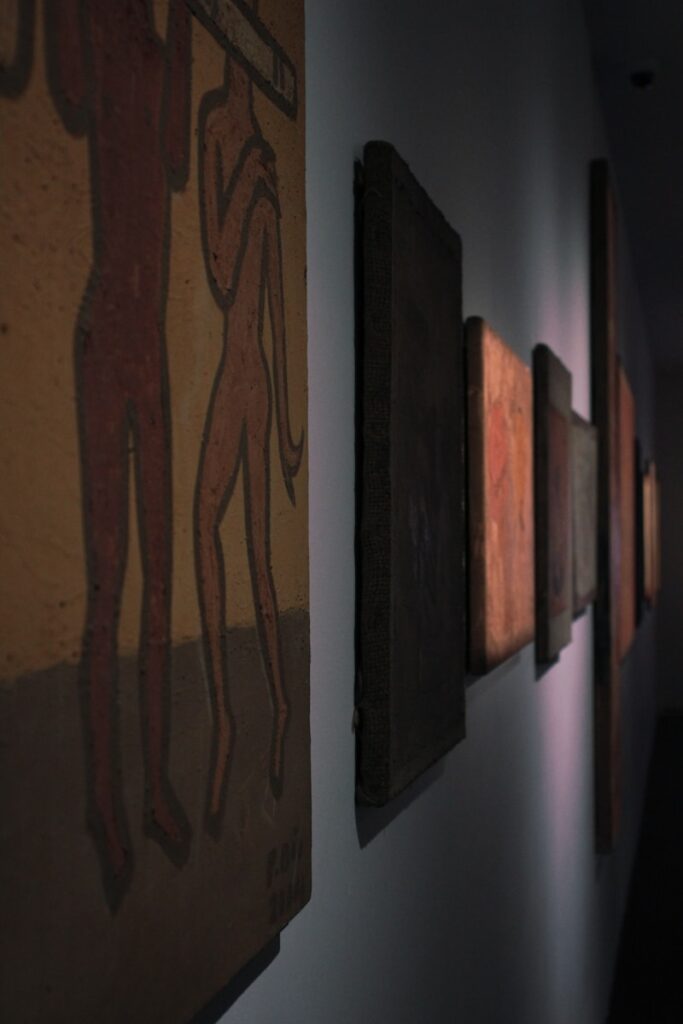 a row of paintings hanging on a wall